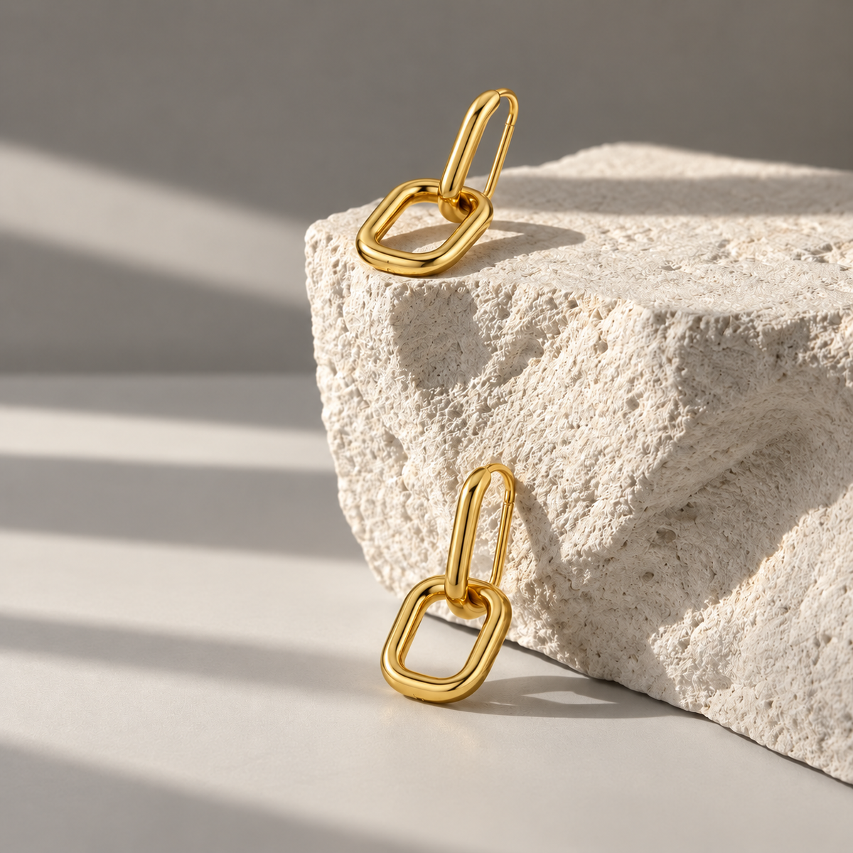 Lyra Gold Link Drops on pale limestone