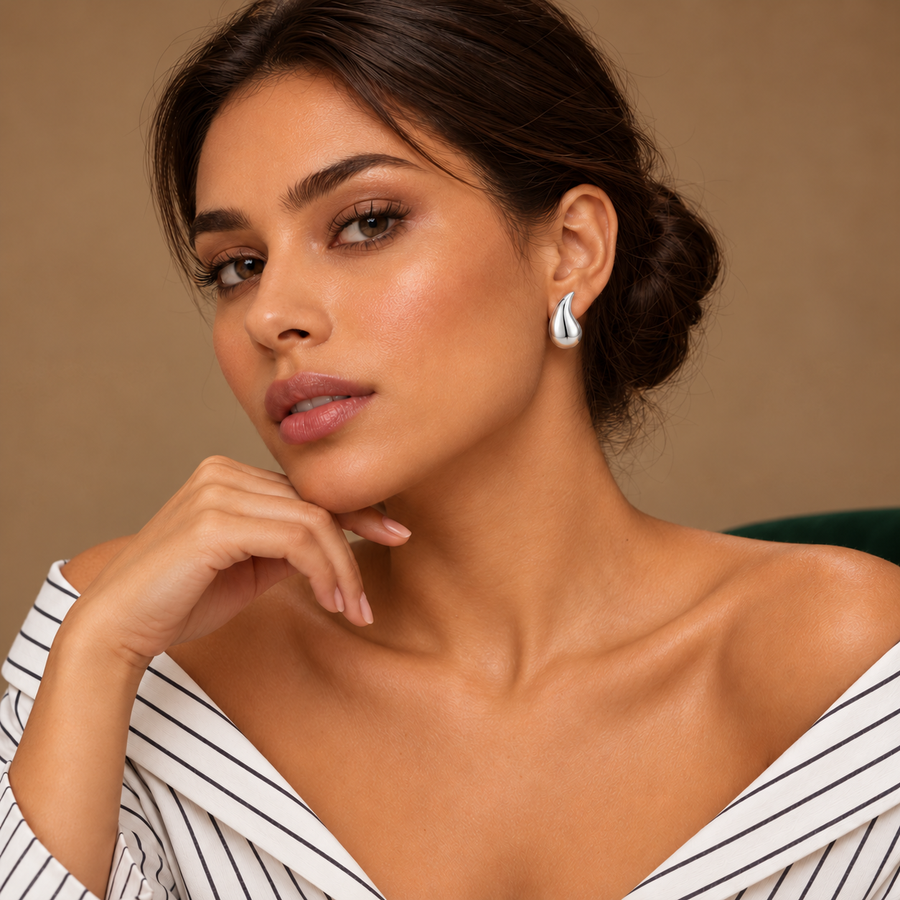 Solène Silver Teardrop Studs worn by a model in an ivory striped shirt